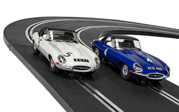 Jaguar E-Type First Race Win 1961 - Twin Pack - Limited Edition This Limited Edition 1961 Jaguar E-Type Scalextric Slot Car Twin Pack is a fitting tribute to the first race and first race win for the iconic Jaguar E-Type! A great performance by both drivers saw the racing career of the legendary E-Type get off to a fantastic start with Graham Hill winning the 25-lap race and Roy Salvadori bringing it home in an impressive third place